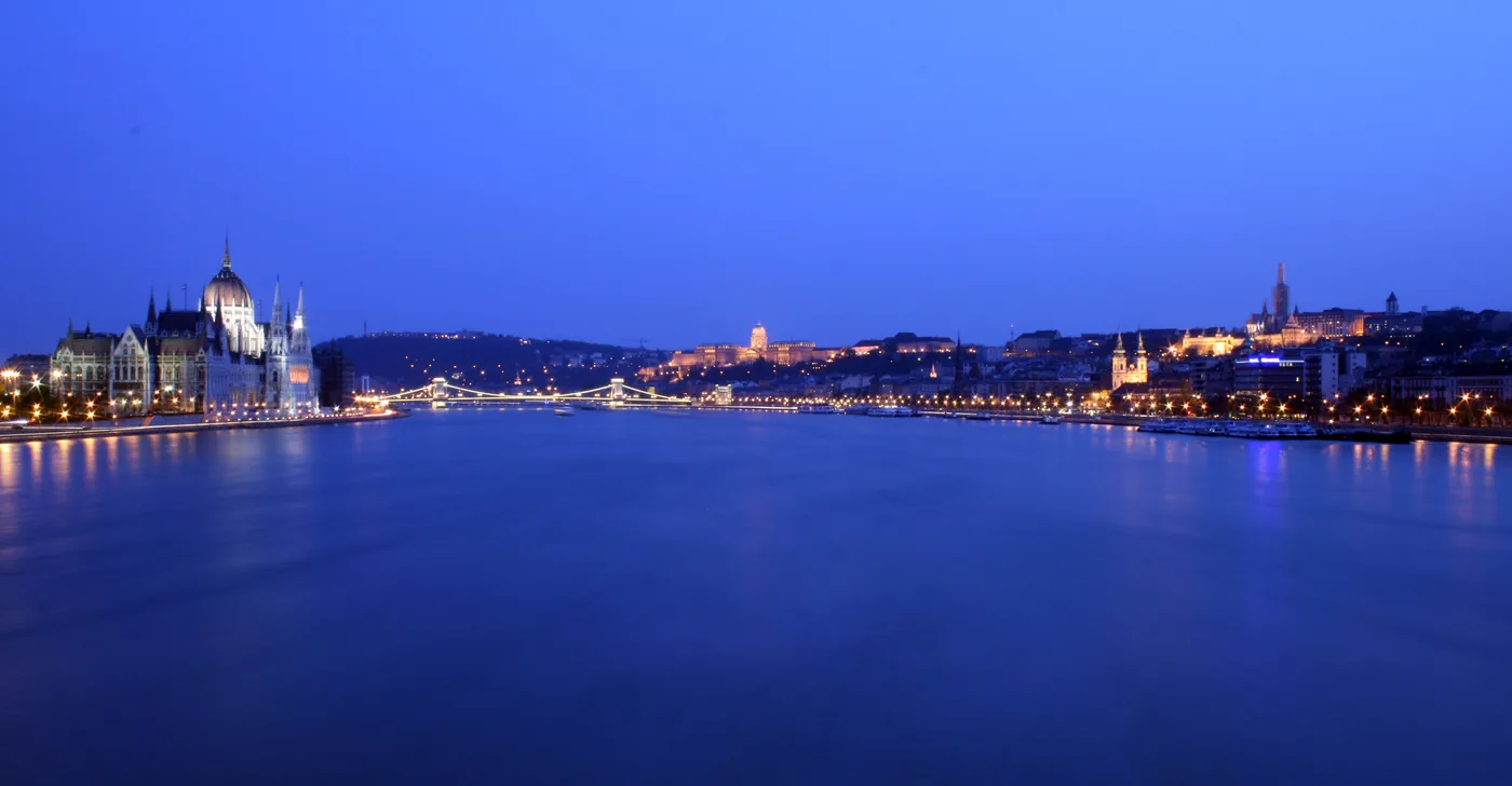 The Danube in Budapest at blue hour, with the lit Parliament and Buda Castle on the banks