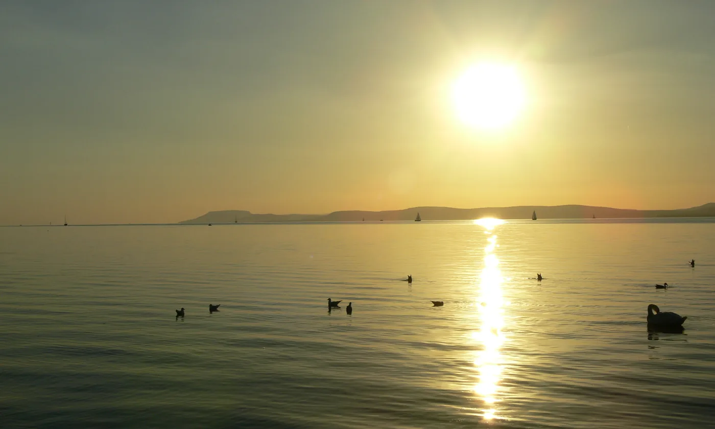 Sunset over Lake Balaton at Balatonföldvár, with the hills of the north shore on the horizon